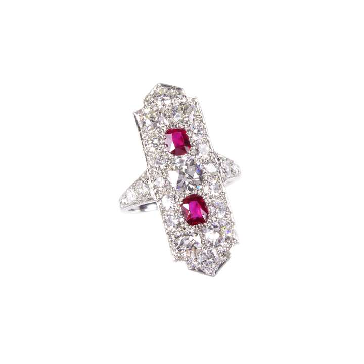 Diamond and ruby panel ring by Cartier, the elongated rectangular panel featuring two cushion cut rubies,